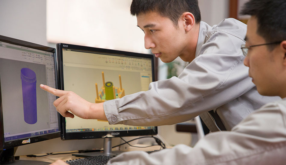 engineers discussing in front of computers